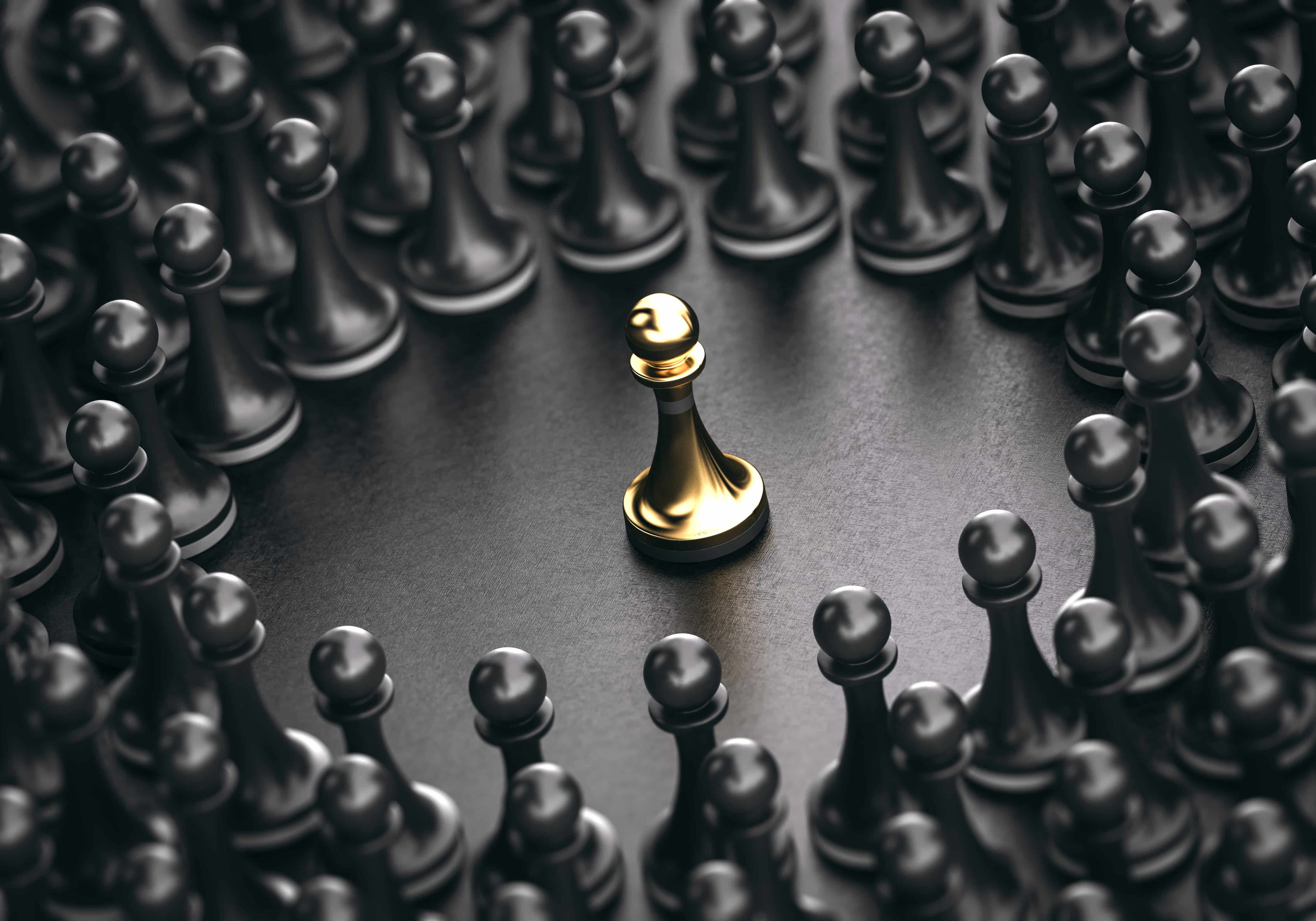 3D illustration of black pawns around a golden one standing out from the crowd. Concept of leadership